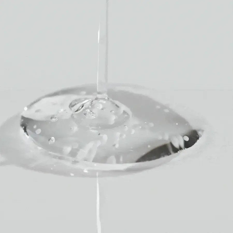 Clear liquid texture of Skin1004 brightening capsule ampoule 100ml showing smooth hydration