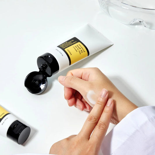 Cosrx advanced snail 92 all in one cream tube with moisturizer being applied on hand