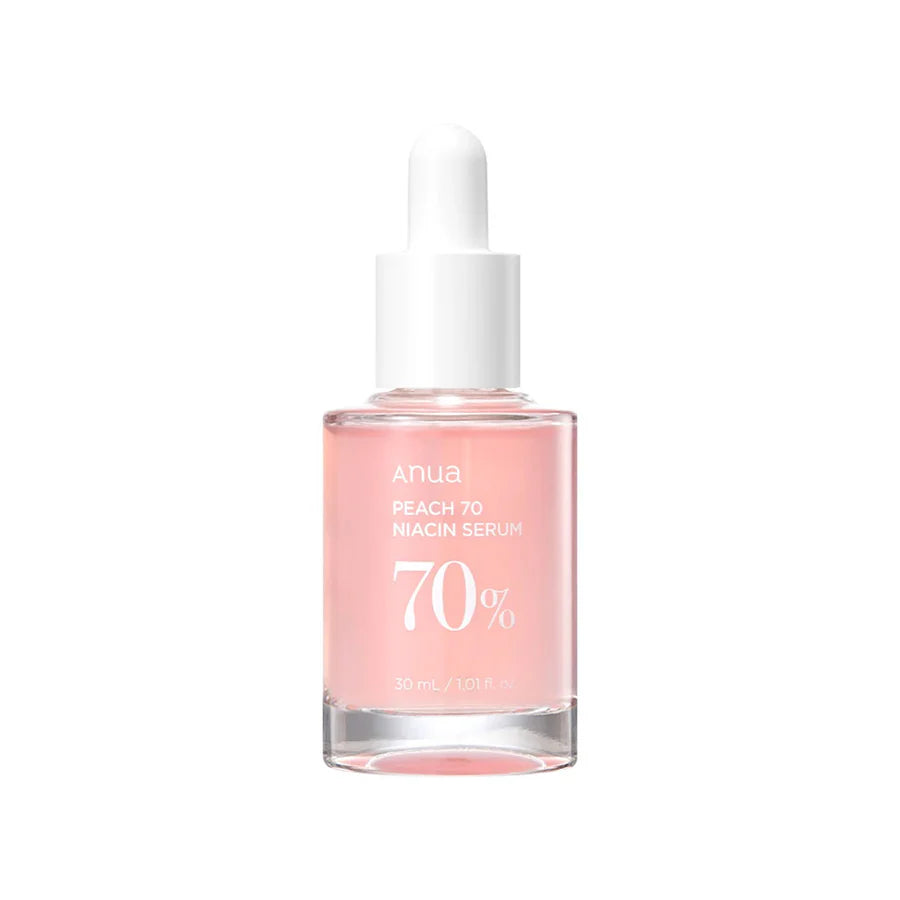 Anua 70 percent niacinamide serum in clear glass bottle with white dropper and peach-colored liquid
