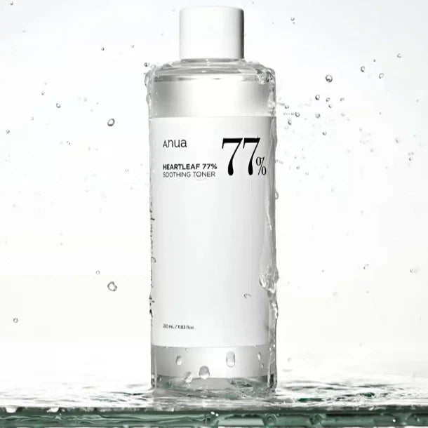 Anua Heartleaf 77 Soothing Toner clear bottle with white label and water splash background