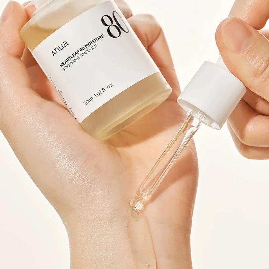 Anua heartleaf soothing ampoule with dropper dispensing clear serum onto hand for skincare