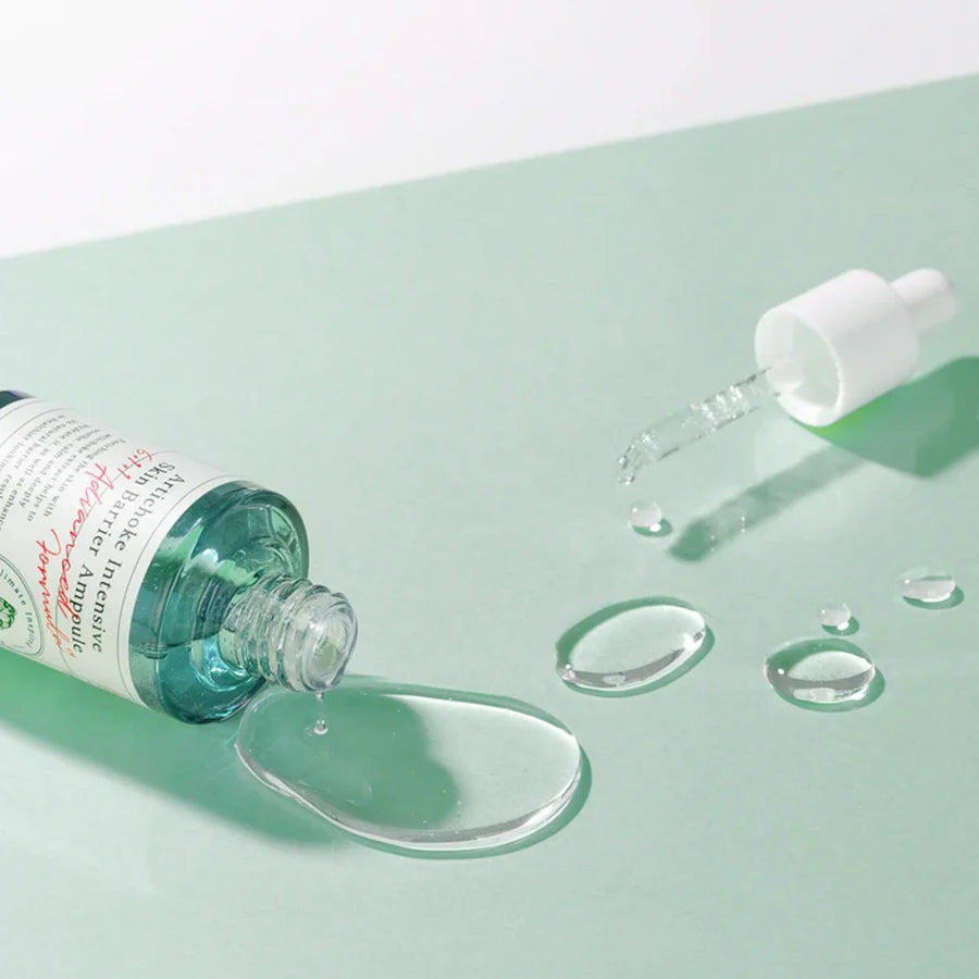 AXIS-Y artichoke skin barrier ampoule bottle with dropper and clear serum spilled on green surface