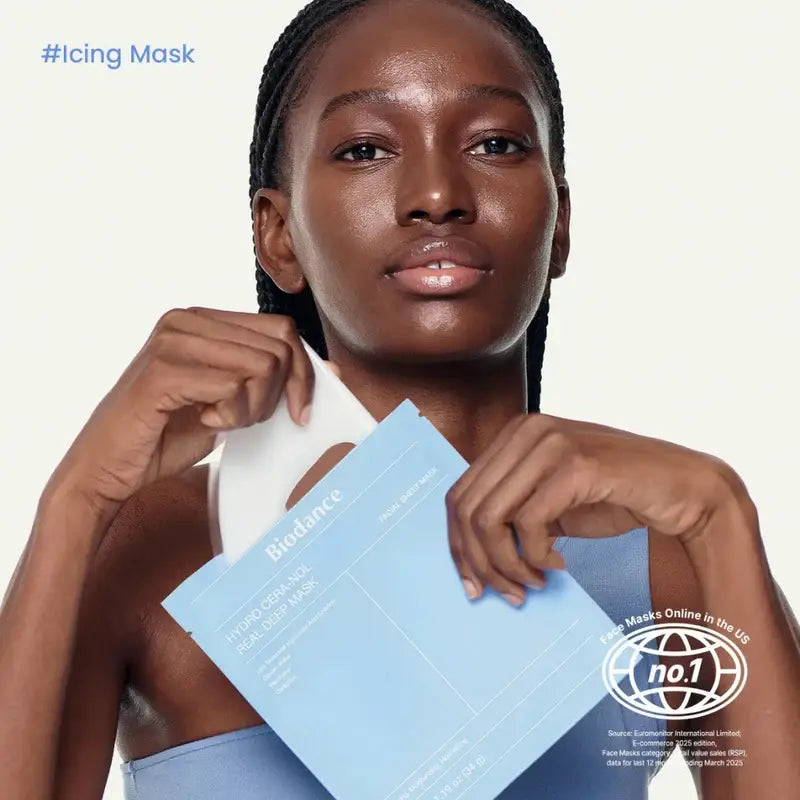 Zuzu Aura face mask packaging held by a model with glowing skin for skincare enthusiasts