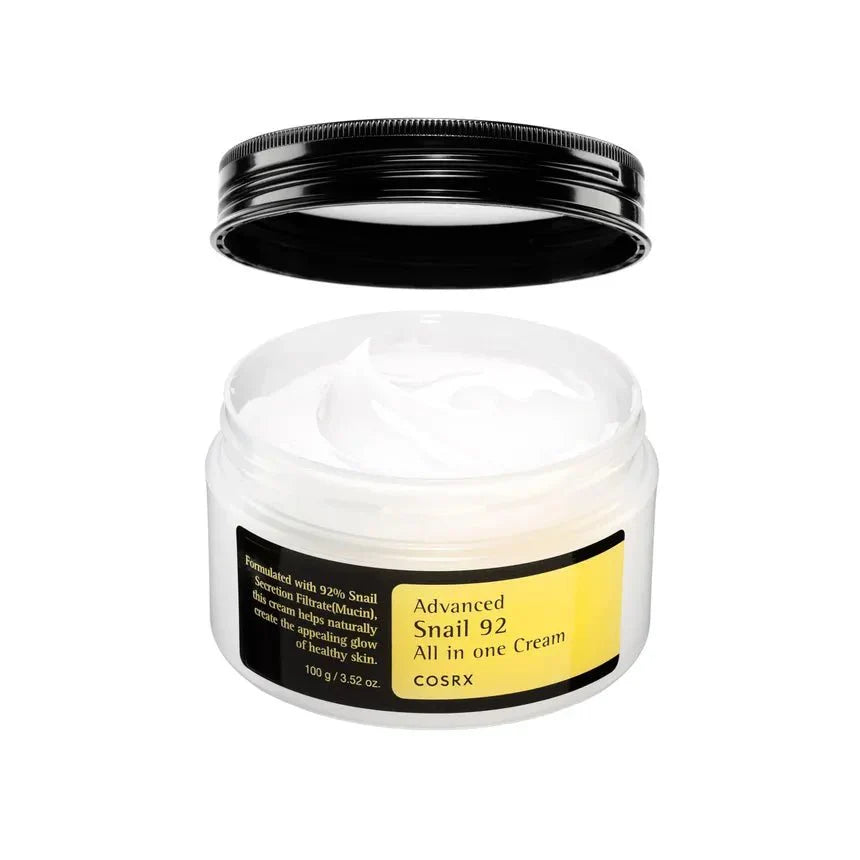 Open jar of Cosrx Snail 92 cream moisturizer with white creamy texture and black lid