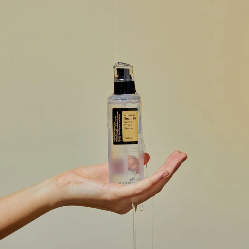 Cosrx Advanced Snail 96 Mucin Power Essence for face in a hand showing its unique texture
