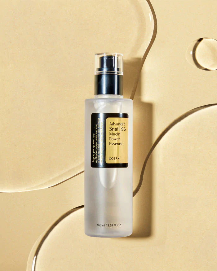 Cosrx Advanced Snail 96 Mucin Power Essence for face in a sleek bottle on a golden background