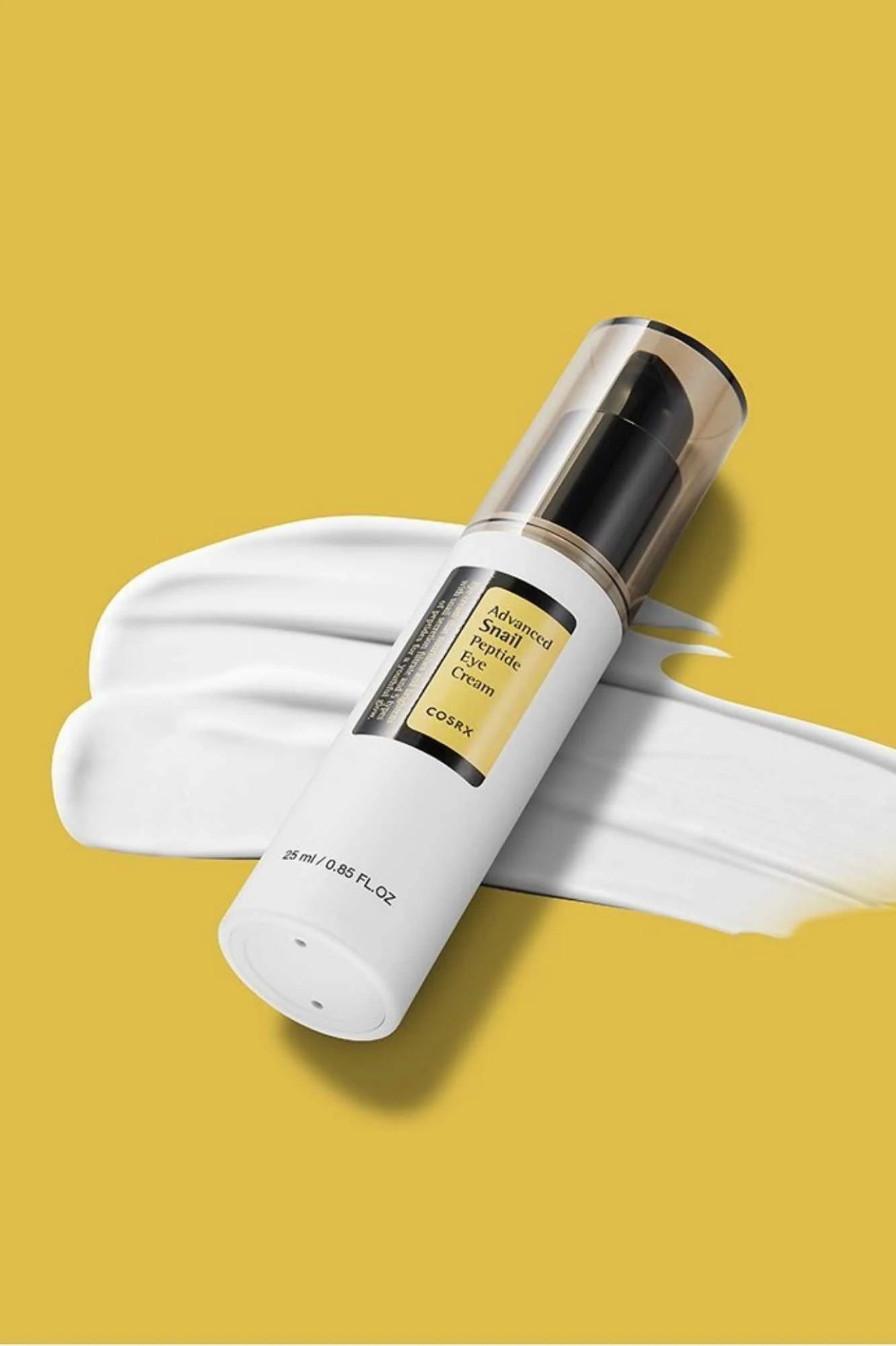 Cosrx snail peptide eye cream bottle on white cream smear with yellow background