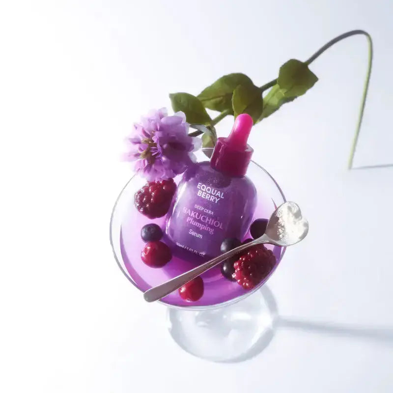Zuzu Aura Equal Berry Bakuchiol Serum in a stylish glass with berries and a spoon for skincare enthusiasts