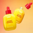 Zuzu Aura C Serum Vitamin in yellow bottles with droppers for brightening skin and enhancing glow