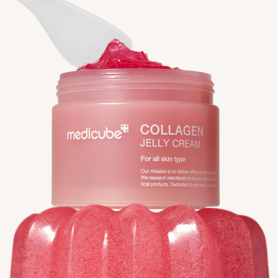 Medicube collagen jelly cream in pink jar with texture on white spatula for anti-aging skincare