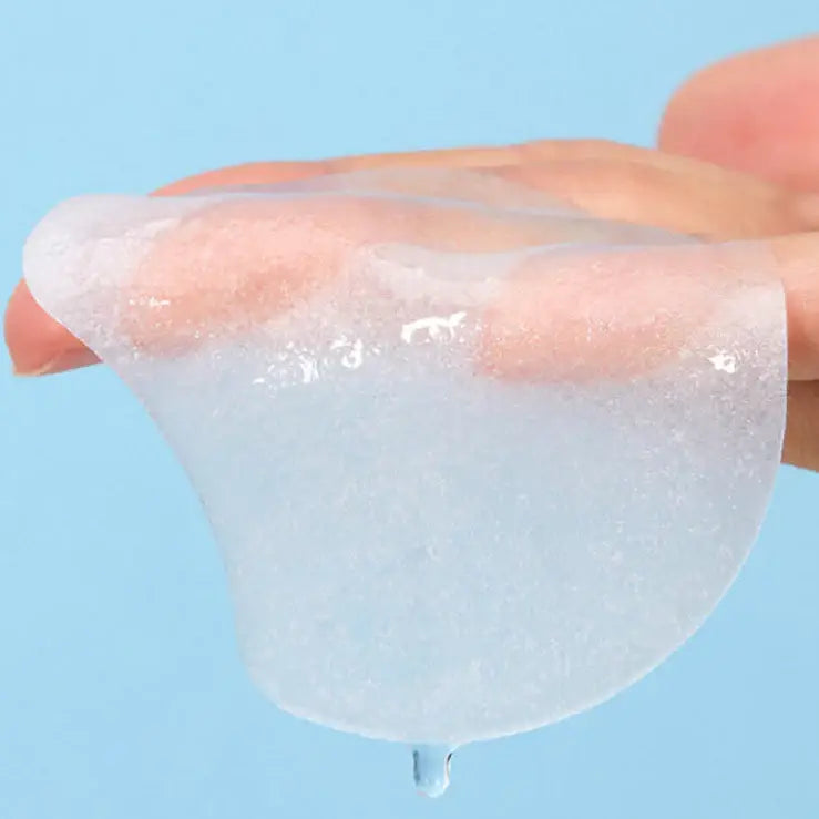 Torriden hyaluronic acid face pads for hydration held on fingers with clear hydrating gel